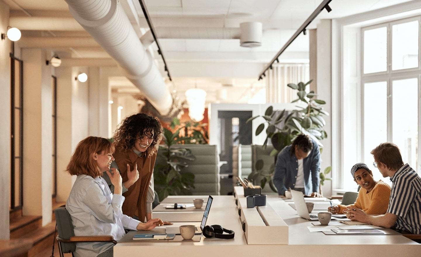 A group of people working around a large desk