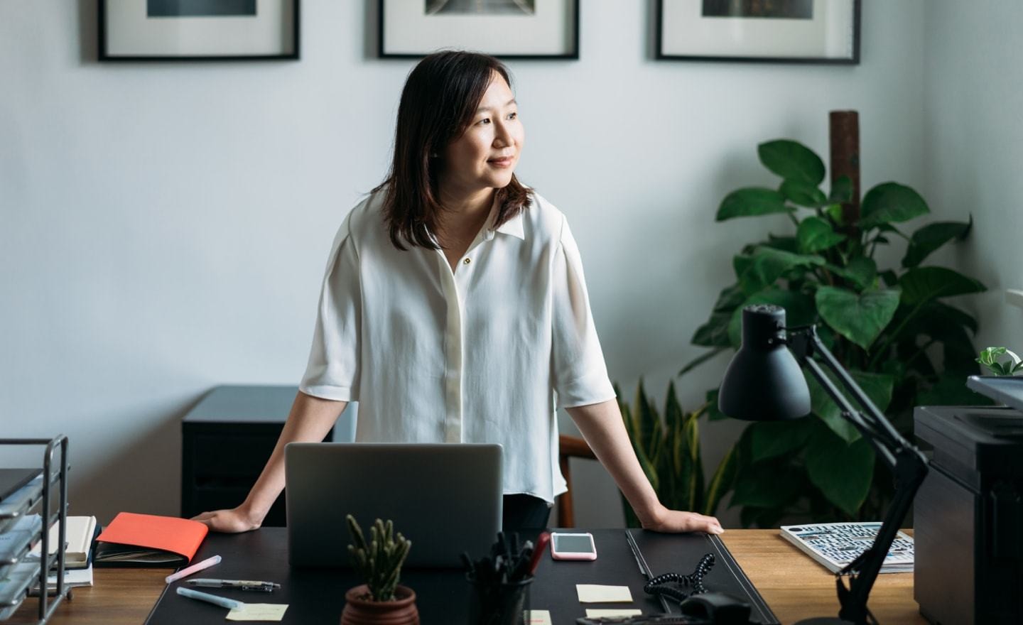 Asian woman at desk looking right