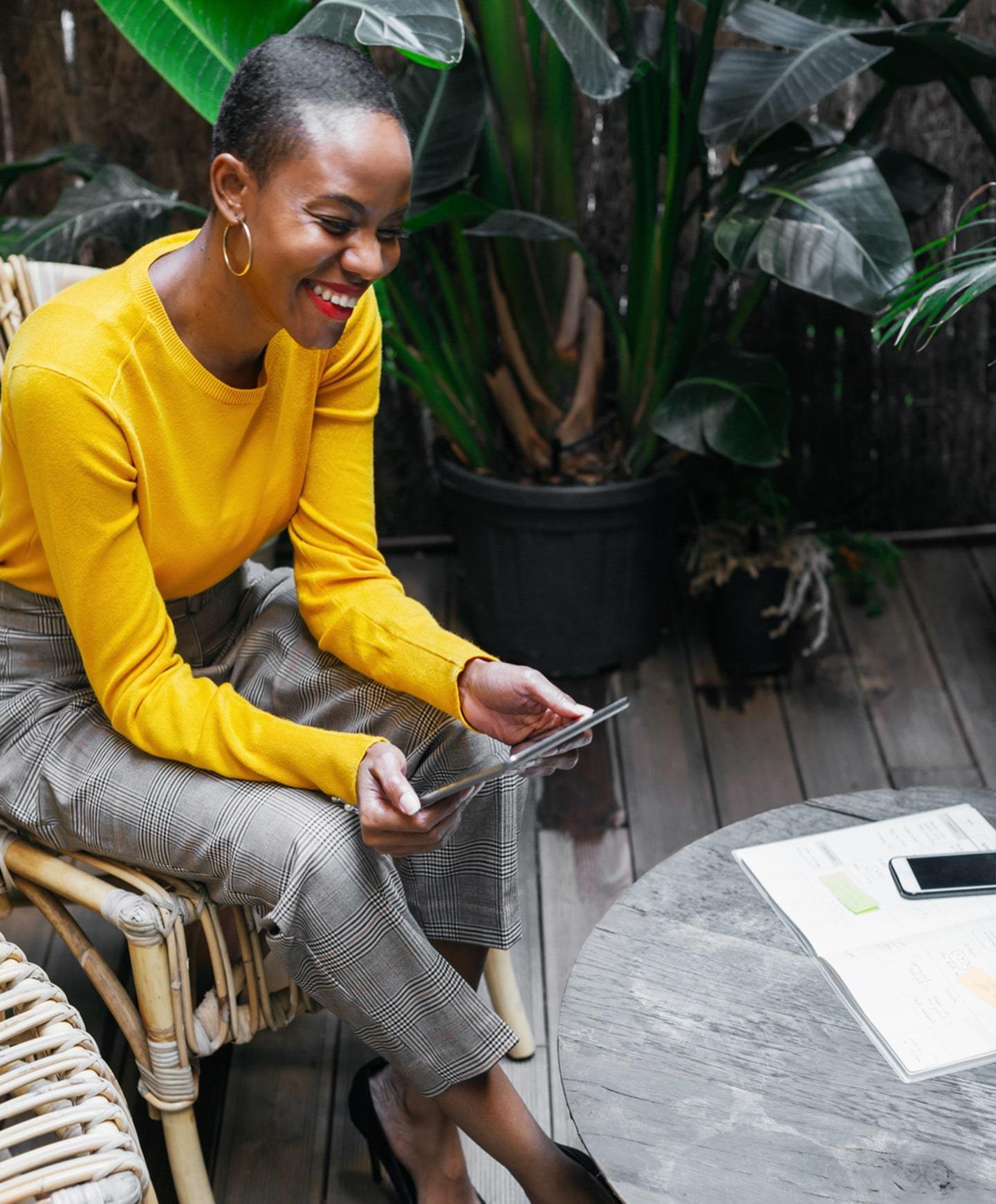 Black woman sitting at a table outdoors