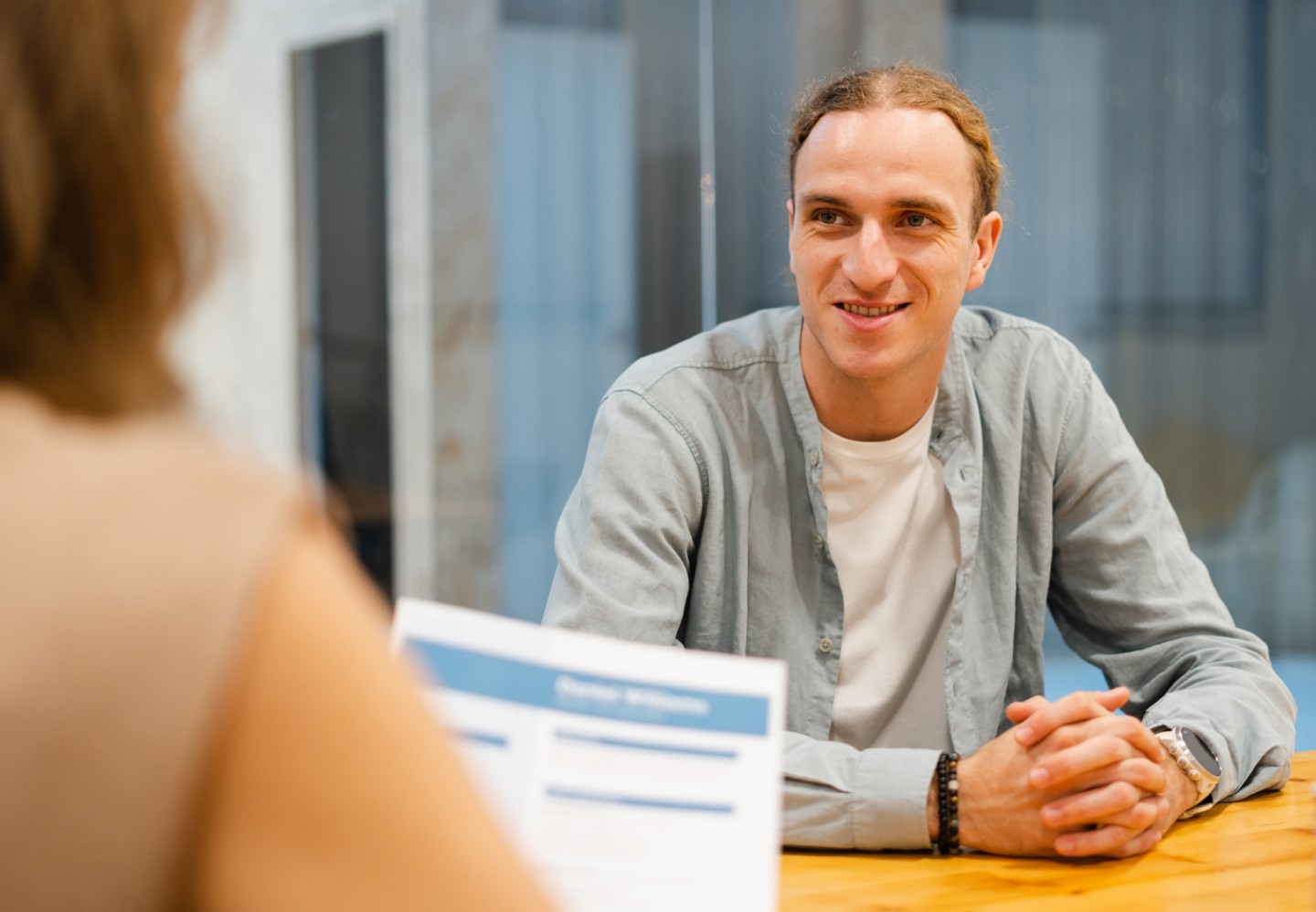 Businesswoman interviews a male candidate in a modern office for a job opportunity