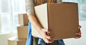 Woman carrying a moving box