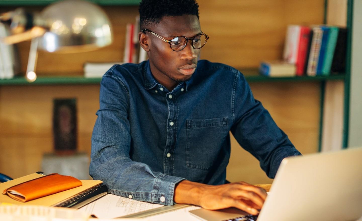 Focused man working on laptop at home