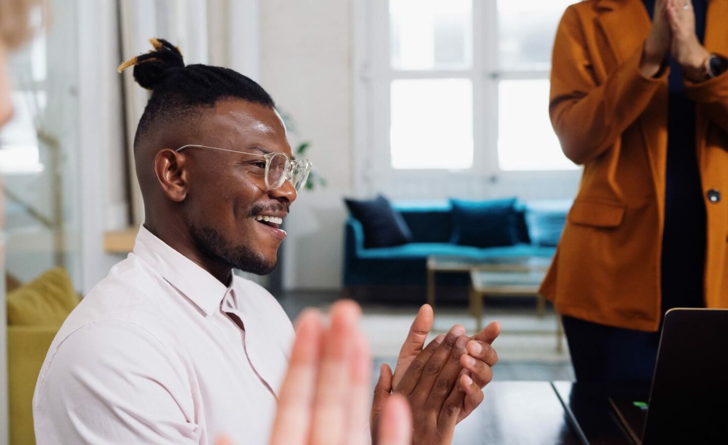 Man clapping in office