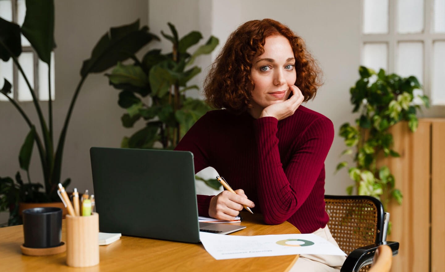 Portrait of a confident woman with laptop in office