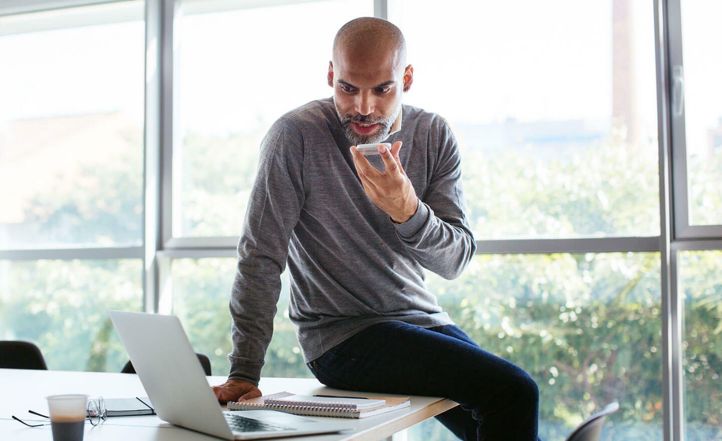 Recruiter on phone with candidate in office