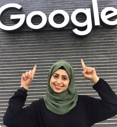 Smiling female arab engineer pointing at google sign