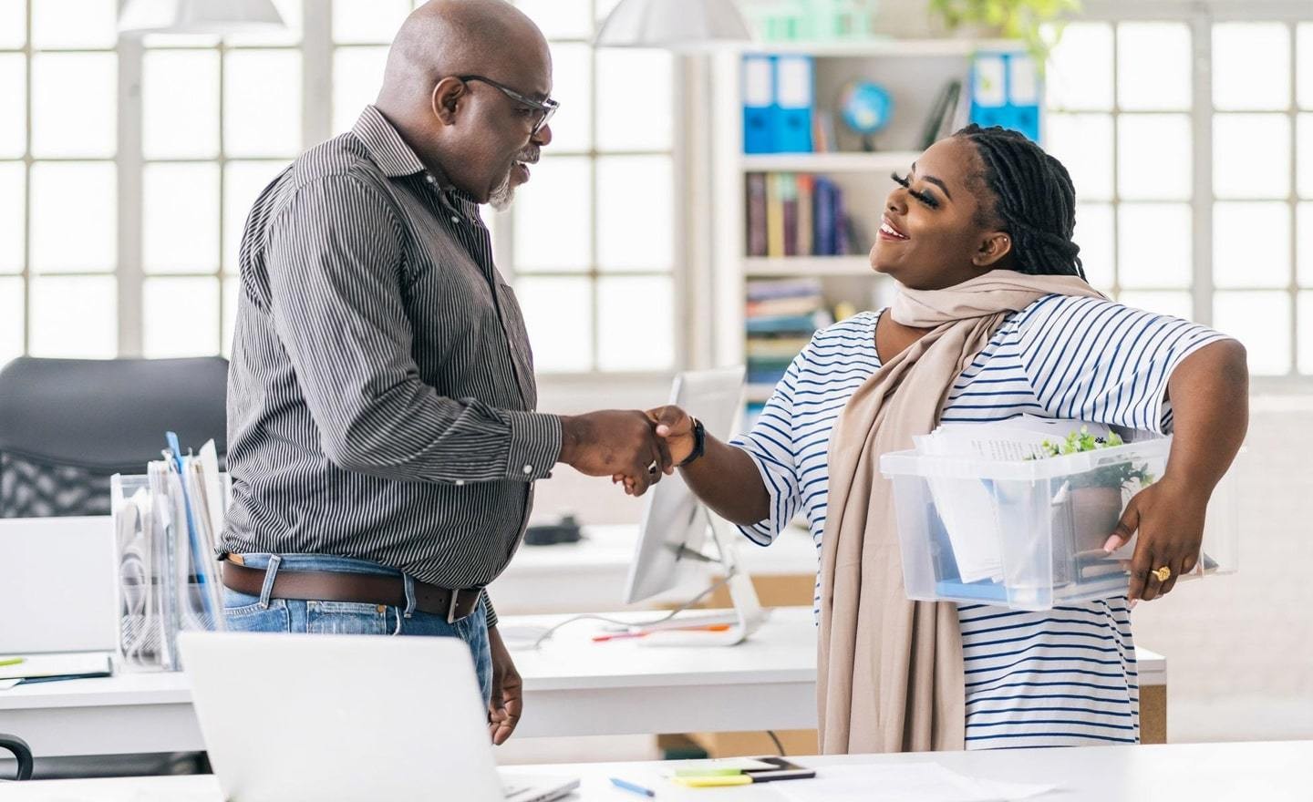 Two black coworkers shaking hands