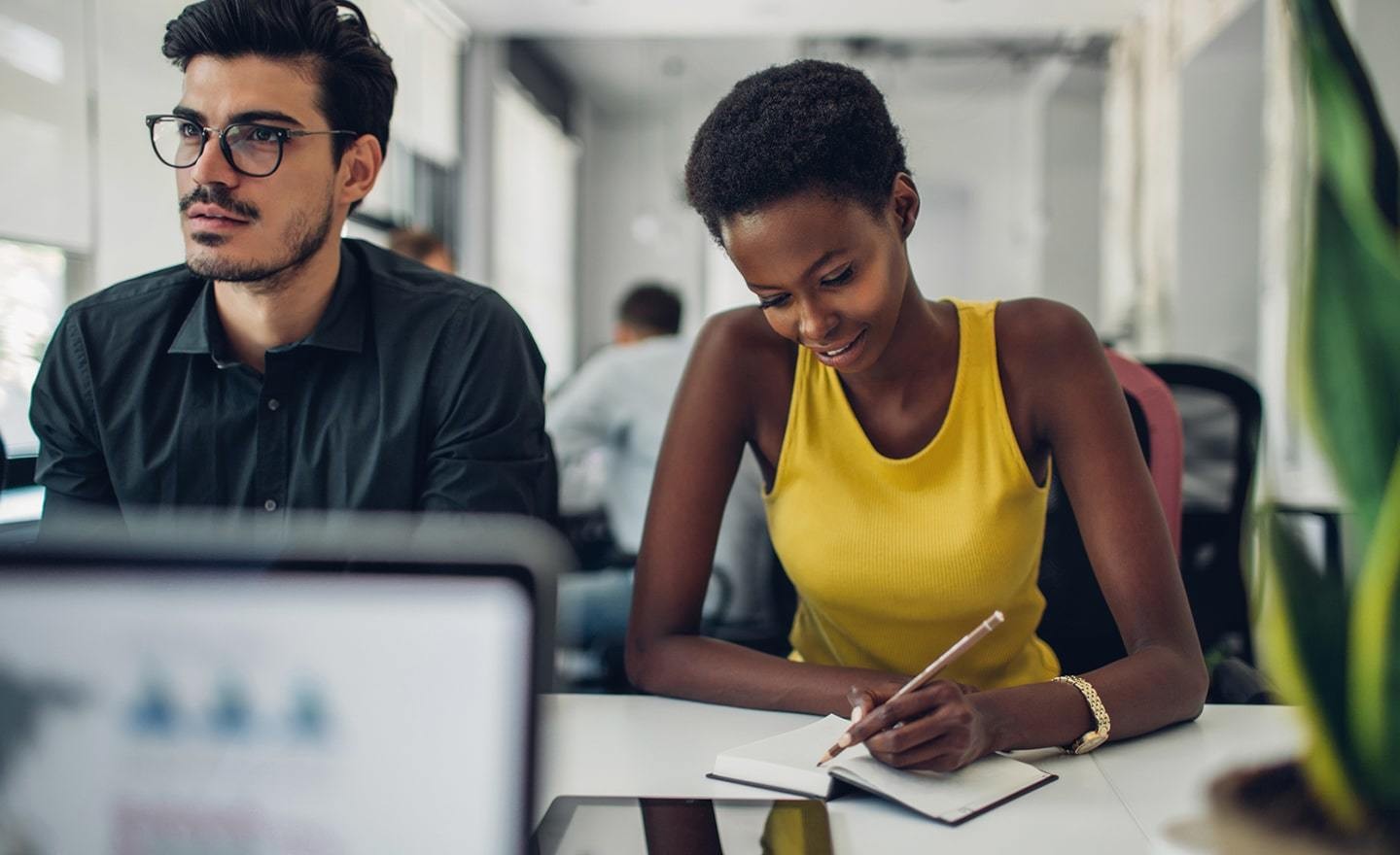 Two coworkers at a desk