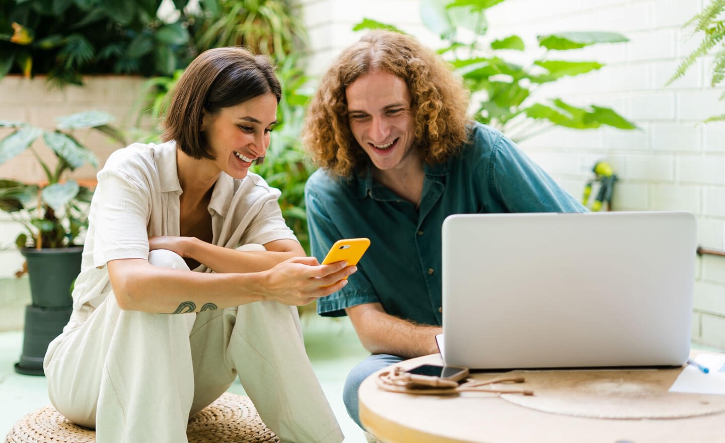 Two coworkers collaborating in plant filled office