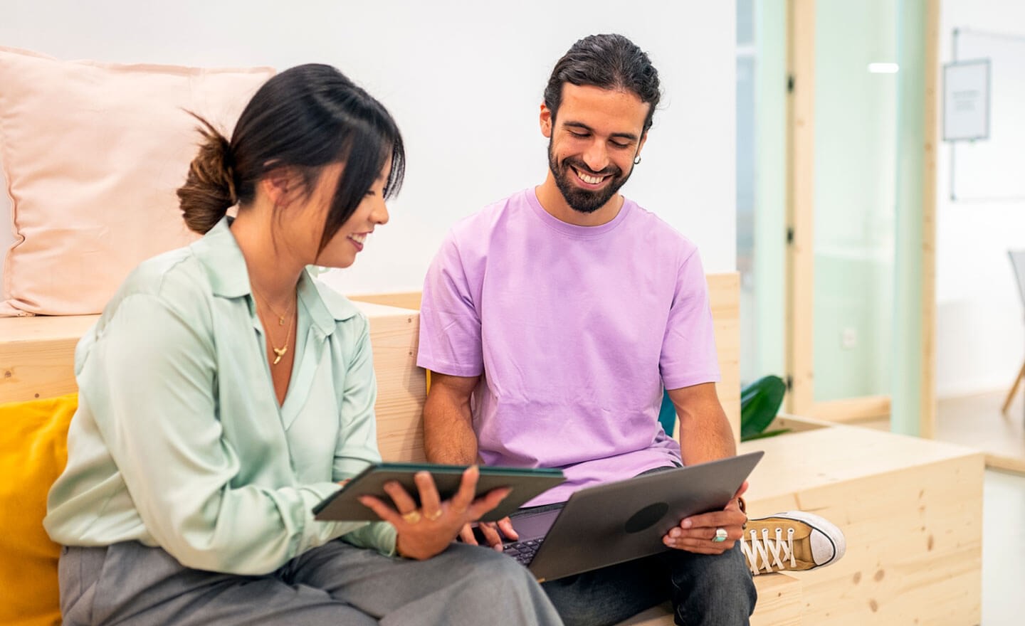 Two coworkers comparing data in office