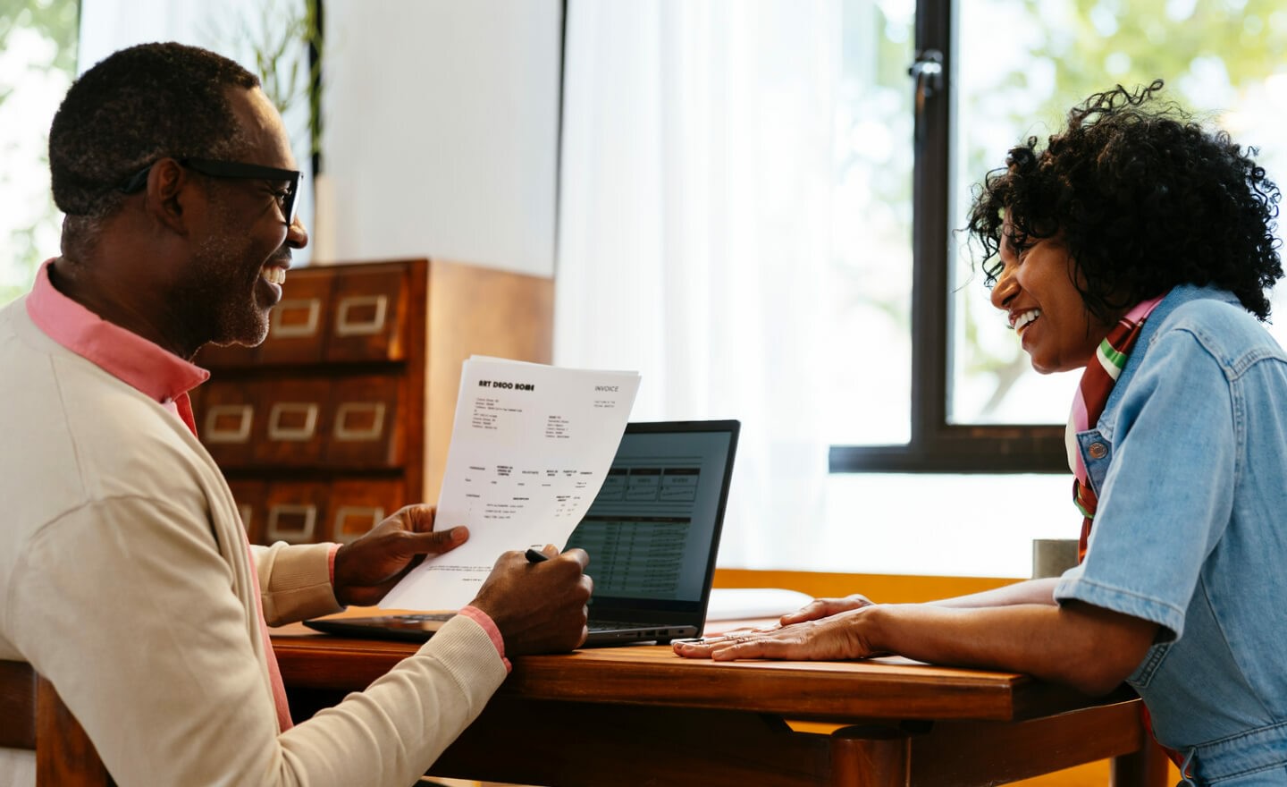 Two coworkers reviewing data on paper