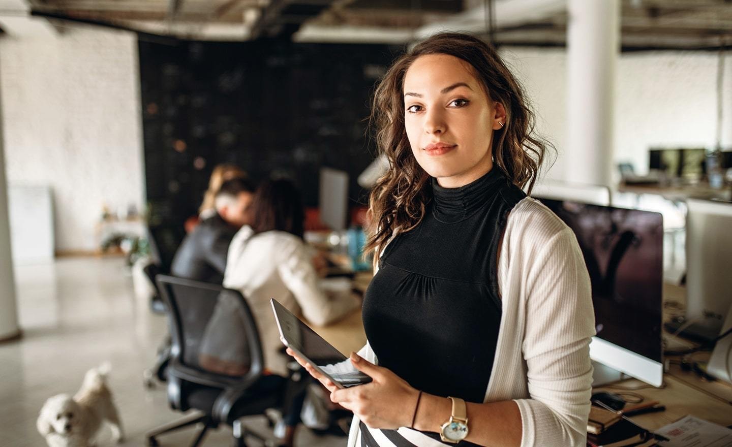 Woman in office holding iPad