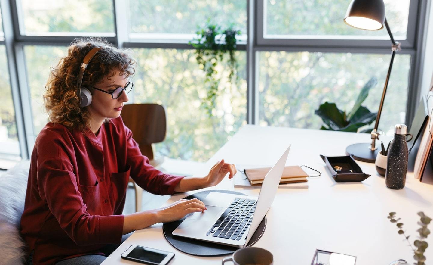 Woman working at a desk using headphones