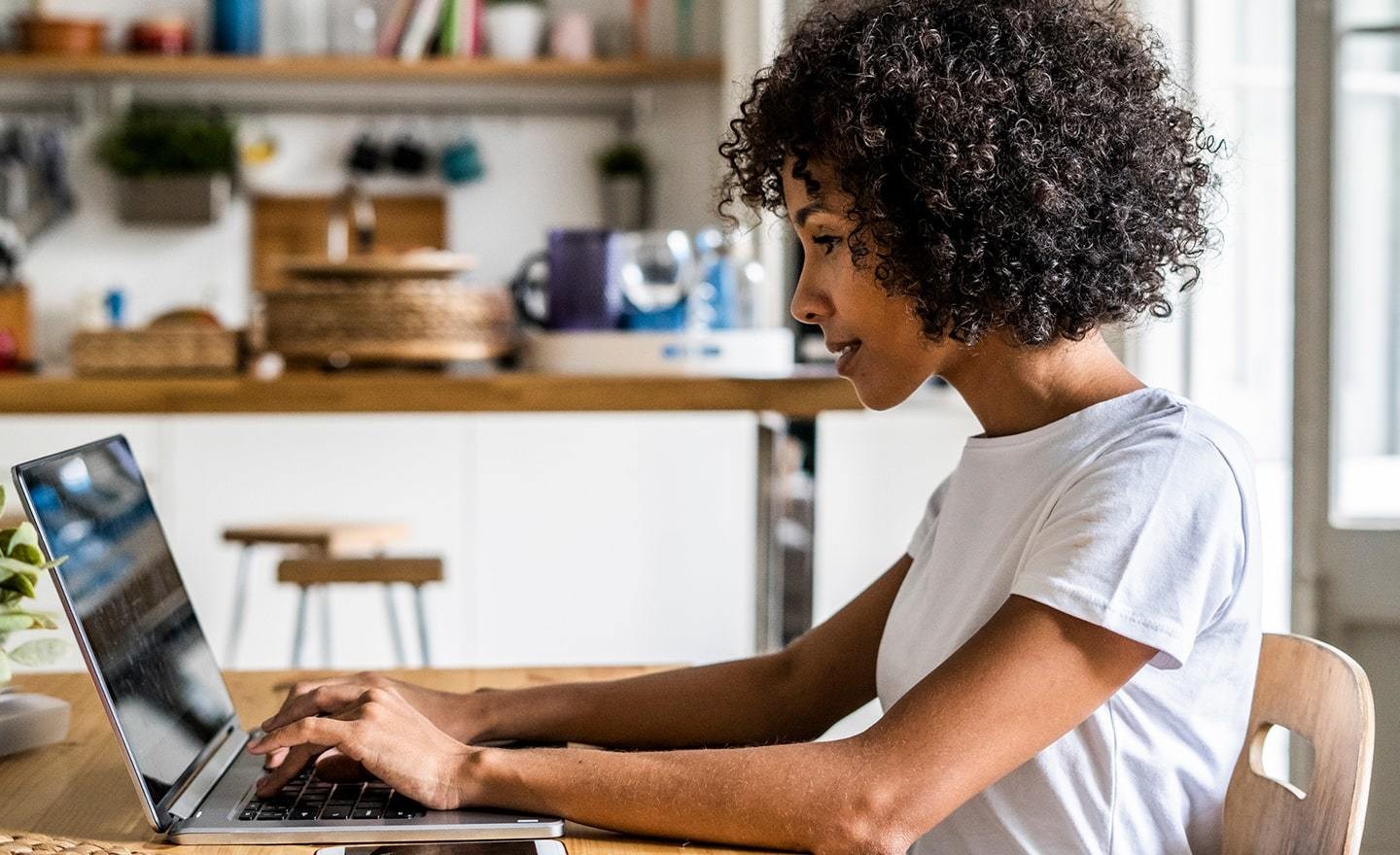 Woman working on laptop at home