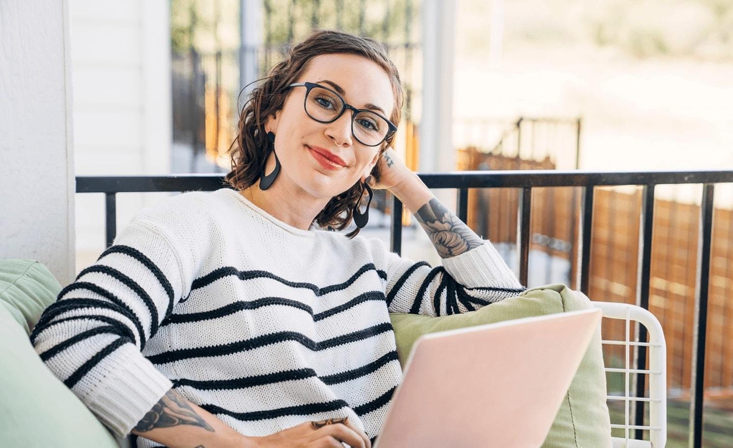 Women with tattoos smiling at camera