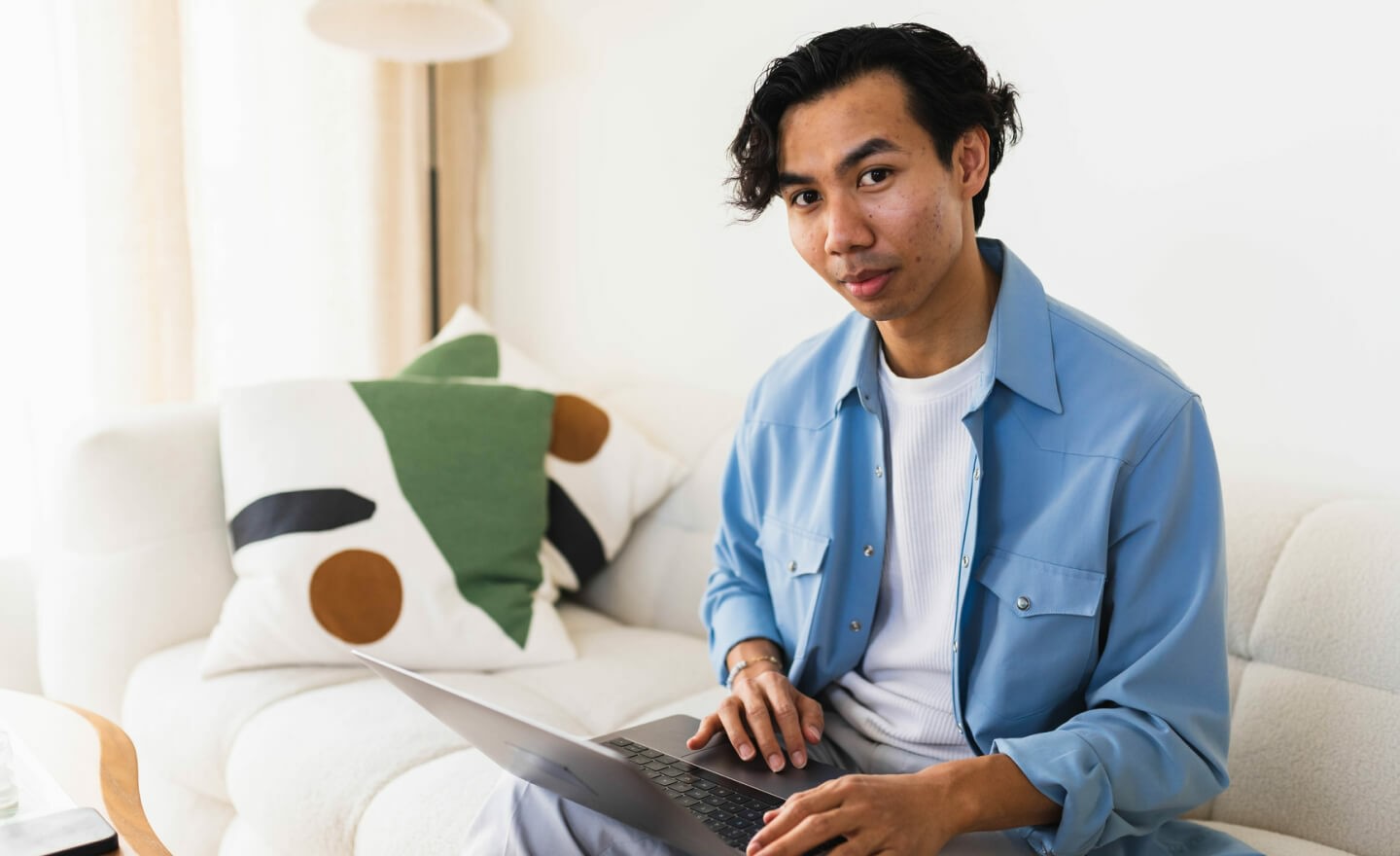 Young person on couch working 720x440