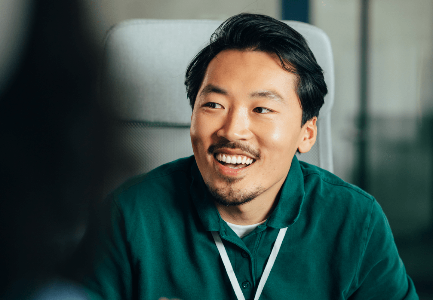 Man with big smile sitting in an office