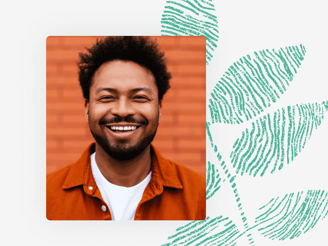 Photo of a smiling Black man in an orange shirt