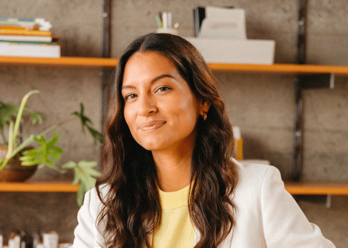 Professional business woman sitting in an office space smiling