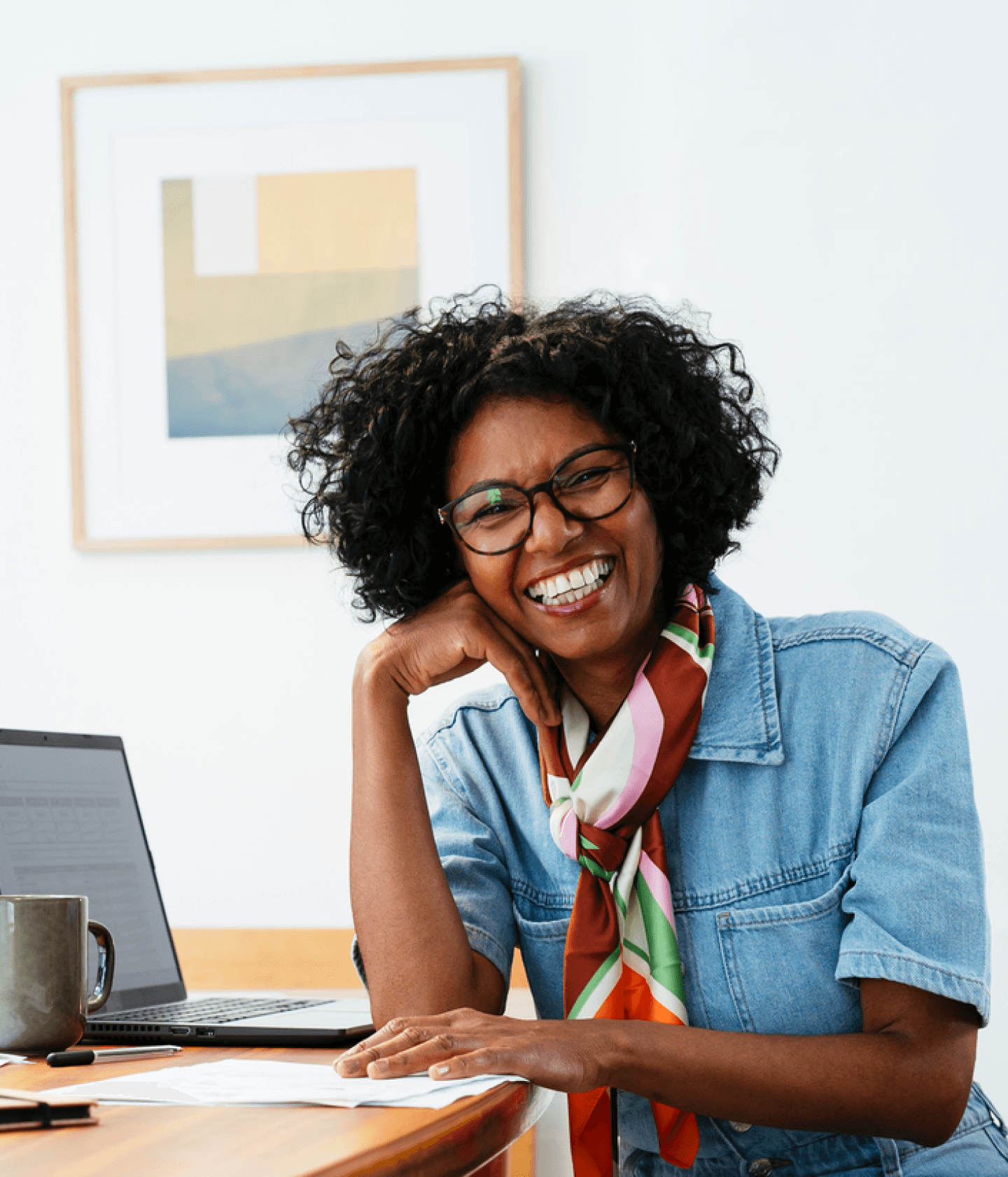 Woman smiling at desk hero