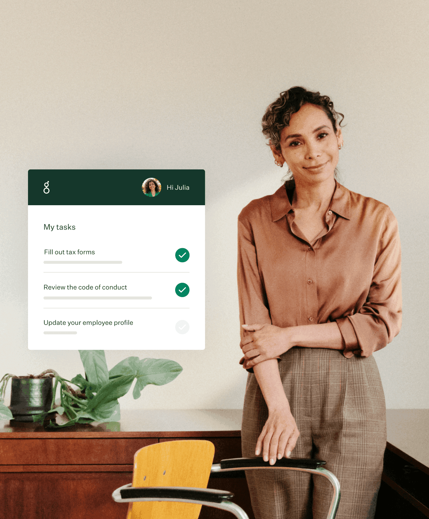 Woman standing in business attire around desk with Greenhouse onboarding new employee tasks UI